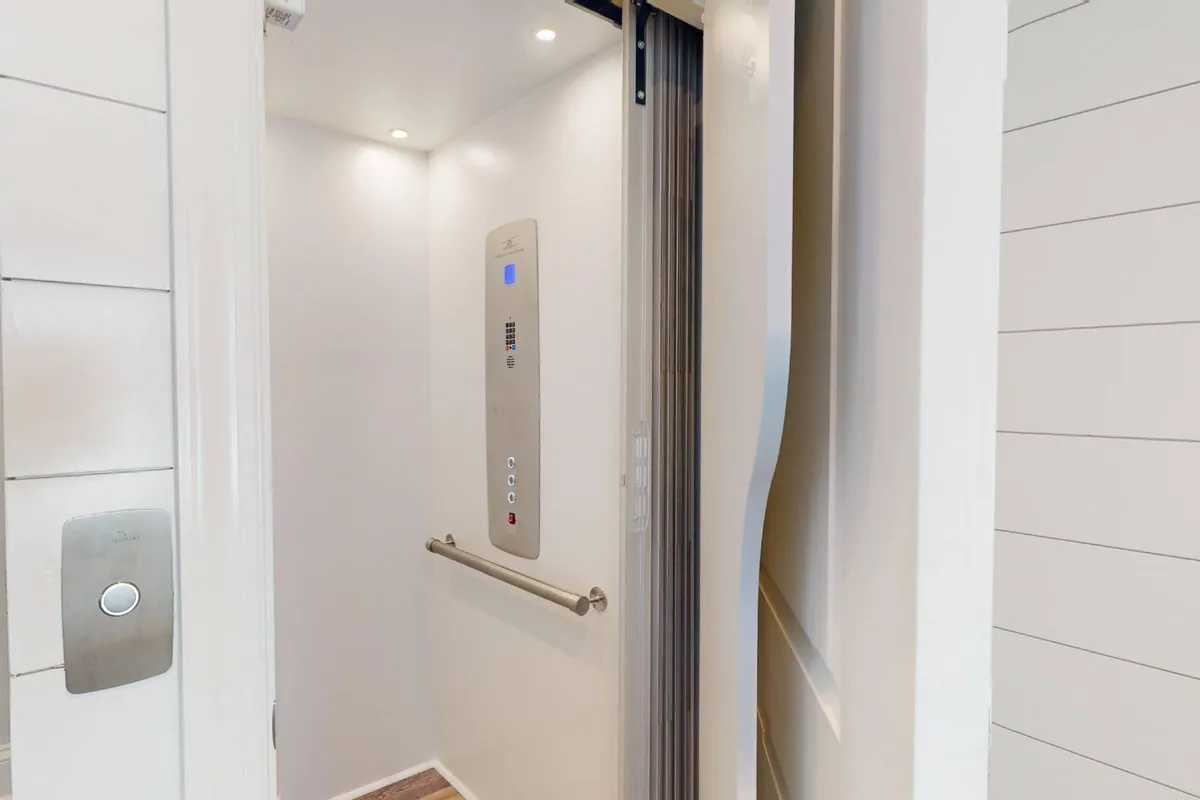 A close-up view of the elevator interior, showcasing its control panel, sleek walls, and bright lighting. The image highlights the modern convenience and accessibility features of the property, making it easy for all guests to move between floors without using stairs.